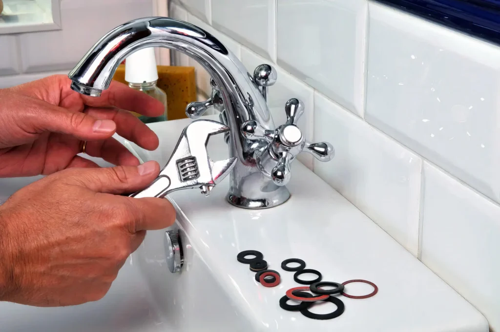 Plumber performing maintenance on a bathroom faucet in Winter Garden