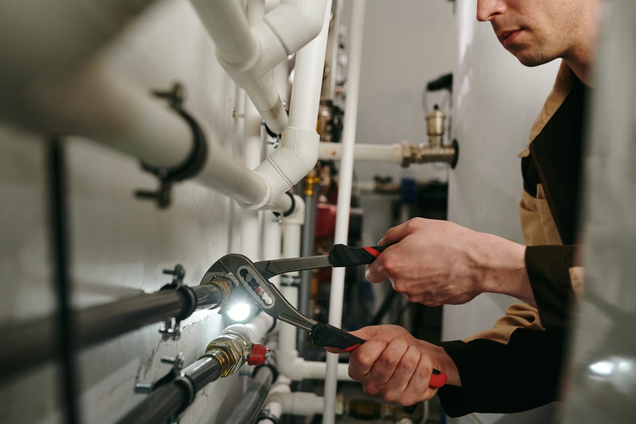 Plumbers maintaining commercial plumbing pipes in Winter Garden