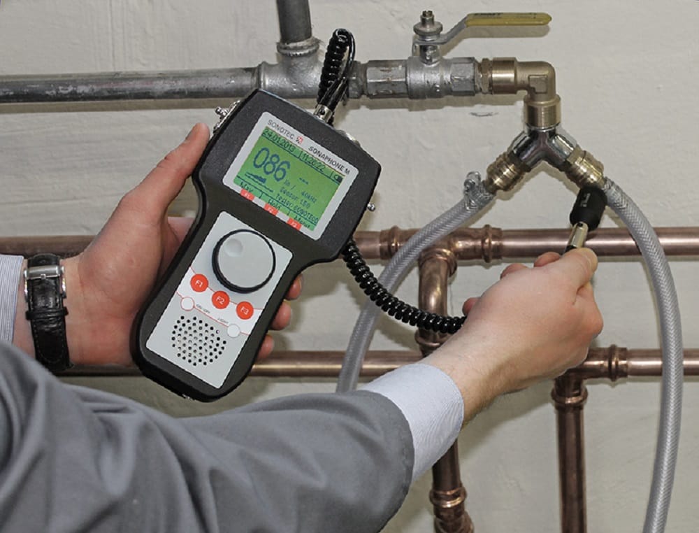 Plumber testing pipes with electronic leak detection equipment in Winter Garden