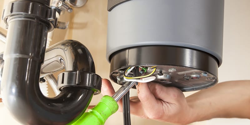 Technician repairing the heating element of a water heater in Winter Garden