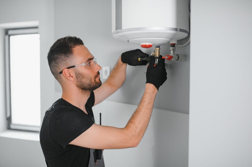 Technician performing water heater maintenance in Winter Garden